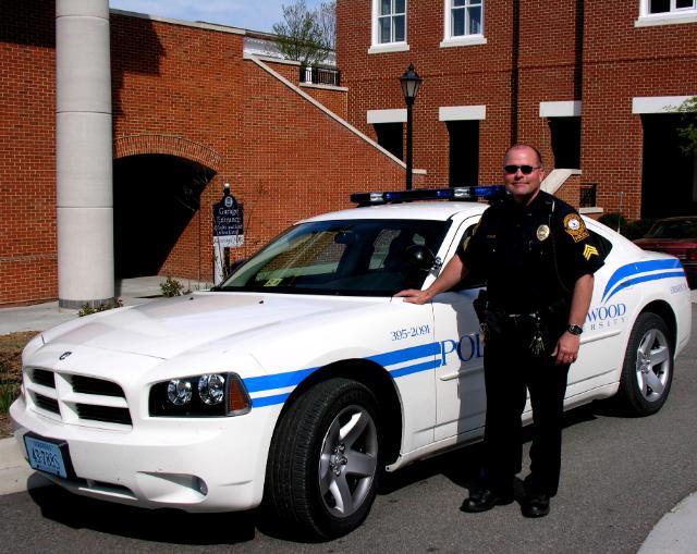 Police Officer with car on campus